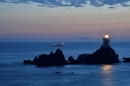 CorbiÃ¨re lighthouse with passing freight ship